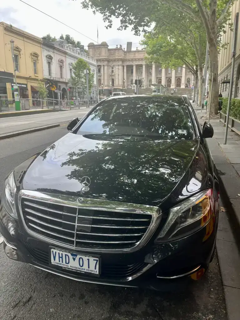 Luxury summer chauffeur transfers in Melbourne — Mercedes-Benz S-Class with skyline view