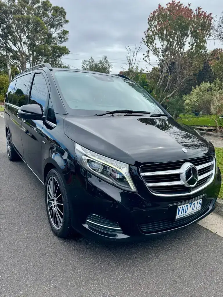 Luxury chauffeur car in Melbourne CBD during summer events, premium black Mercedes for Australian Open and concerts transportation.